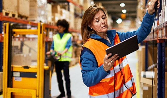 female warehouse worker checking inventory