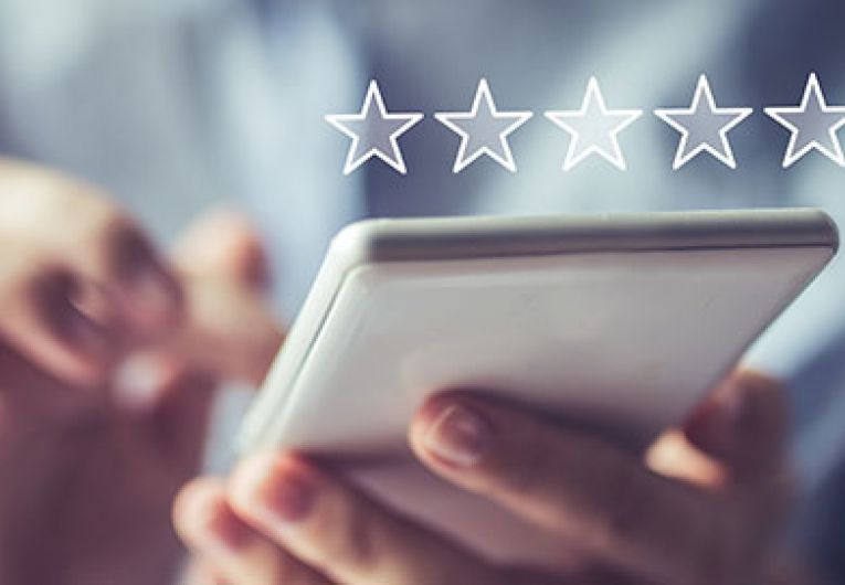close up of person using phone with a star rating superimposed
